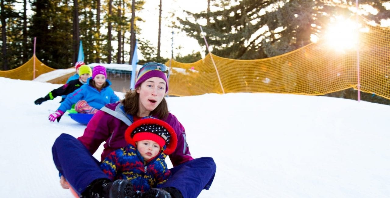 Mother and baby sledding in Lake Tahoe at Tahoe City's Winter Sports Park