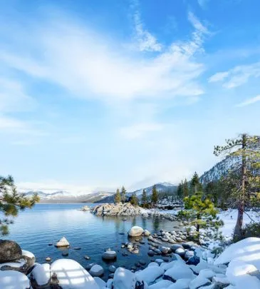 Snow covered rocks at Sand Harbor in Lake Tahoe during winter