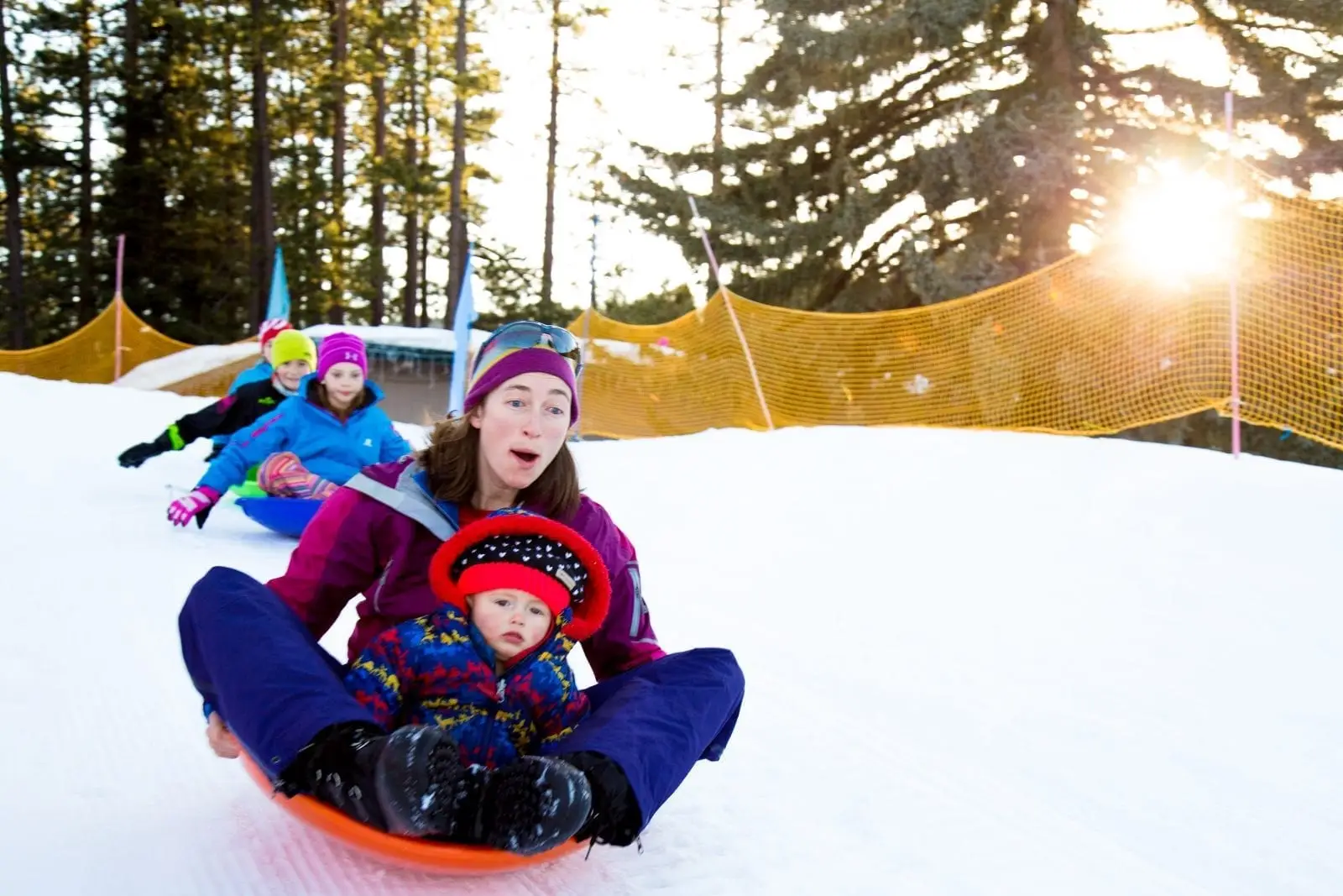 Mother and baby sledding in Lake Tahoe at Tahoe City's Winter Sports Park