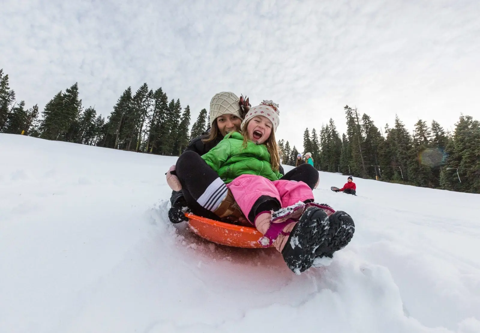 Mother and daughter sledding in Lake Tahoe at Granlibakken